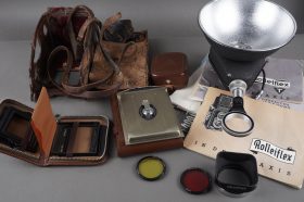 a bunch of Rolleiflex items, most genuine, masks, flash, case, literature