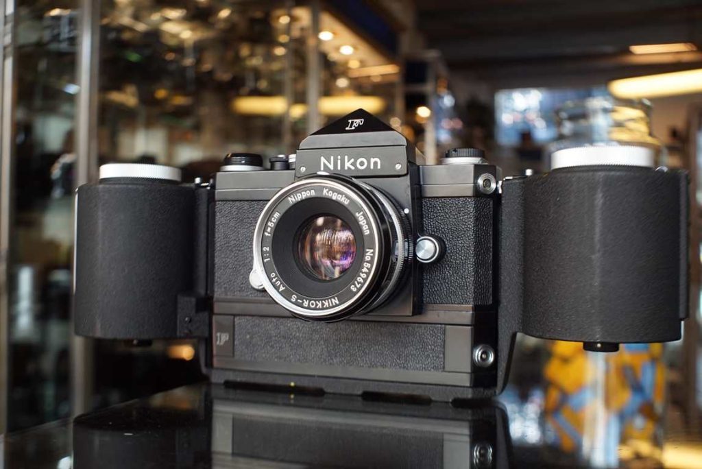 Nikon F in black with the famous plain prism finder and a F-250 film back attached. This kit is outstanding condition and a must have for any serious Nikon collector. The cosmetics are just superb, as good as they get. Some mini marks here and there but overall in such a nice condition. Camera fires, the shutter speeds sound ok but were not machine tested extensively, the kit is sold for collection purposes. No dents in finder. Super clean lens. Comes with cassettes inside the F-250 back.