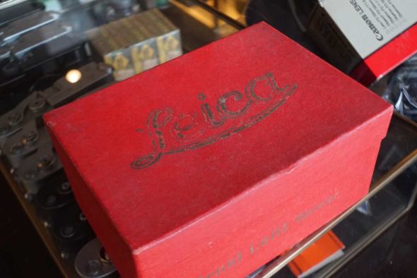 Red Leica box filled with 15 vintage war-time film boxes and cannisters