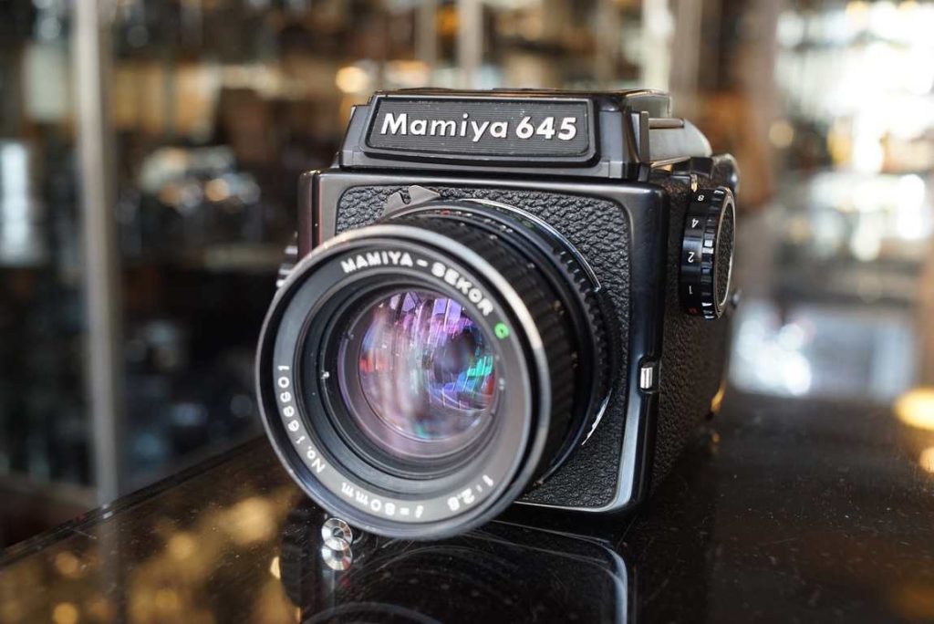 A fully working Mamiya 645J camera with matching 80mm standard lens. All the shutter speeds are working as intended, machine tested. Focus on lens sometimes bit irregular in terms of its smoothness but works fine in normal conditions, its not too heavy. Good optics, some tiny dust specs that will never show up in final images. Aperture works as intended. Our technician installed new light seals in the back of the camera, so these are fresh and good to go for years. WLF opens and closes as inteded. Some normal usermarks around but no damages or dents. A good working and nice looking user M645J kit.