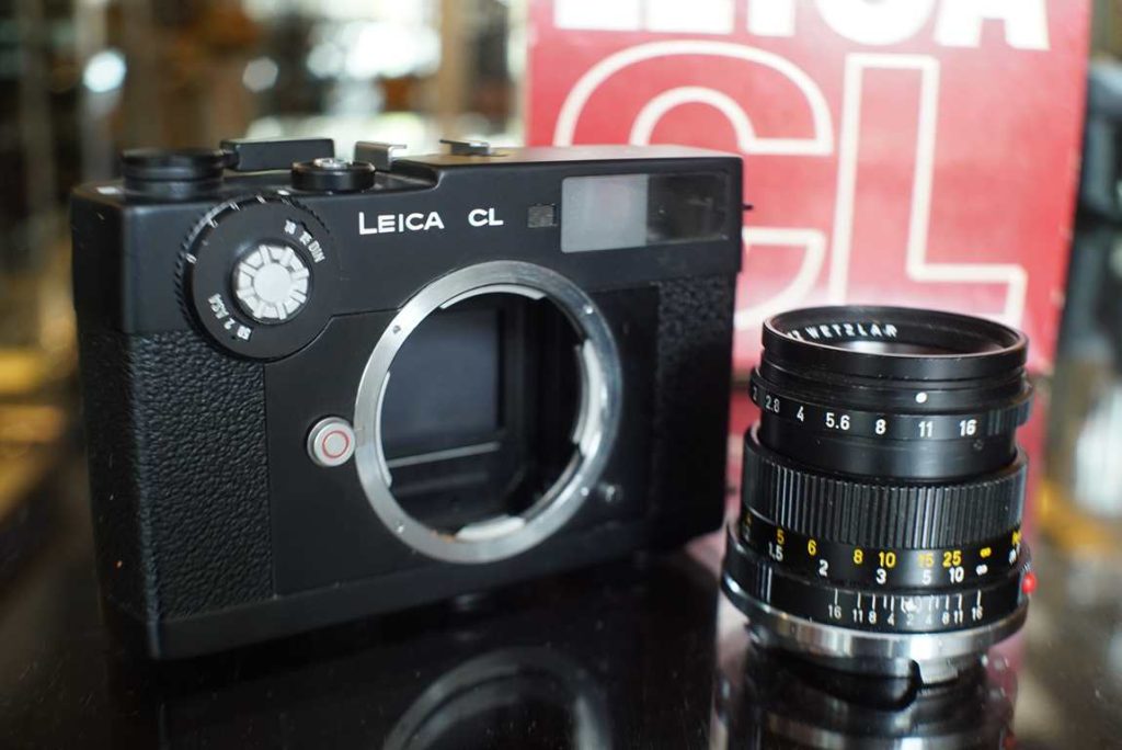 This Leica CL is not able to take pictures. It's a dummy camera that was used by retailers to demonstrate or fill cabinets with the release of the CL. Its's fitted with a dummy Summicron 50mm F/2 version 3 lens as well. The camera has exactly the same housing as a working one would have, but just does not have any internal mechanics. The lens has a working focusing ring and aperture ring and can be taken off the camera. Comes in a Leica CL box. Nice for collectors since this is a really rare piece to find, it was only distributed to Leica dealers and never sold openly on the market.