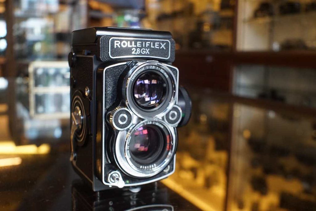 Beautiful Rolleiflex 2.8GX TLR camera with Rollei HFT 80mm F/2.8 taking lens and built in light meter. Truely an unique camera since its the only Rollei TLR with built in meter, which hugely improves its usability. This GX recently was CLA'd by Camera Revival Belgium by its previous owner (spring 2024). All mechanisms work perfect and feel well lubricated. The shutter speeds are bang on and the light meter is accurate on all EV. The battery compartment is not damaged or corroded. The taking and viewing lens are very clean and do not suffer from scratches or visible coating damage. The focusing screen, a grid pattern with split image focus aid, is very clean and only has a few normal user marks, no big scratches or dark spots, just some dust specs. The focus knob feels smooth and accurate. Not only does this GX function like new, it also looks amazing still. Its of course not an old camera in Rollei terms, but for a user copy it really was taken care of by the previous owner. Some mini usermarks around, no damaged parts, just faint marks on corners or the film memo holder. It comes with lenscap.p.s. Make sure you get the proper batteries from good brands like Duracell or Varta, cheap ones won't work well in this camera because a mini design difference in the batteries barrel/housing and contacts.this item comes with a 3 month limited warranty