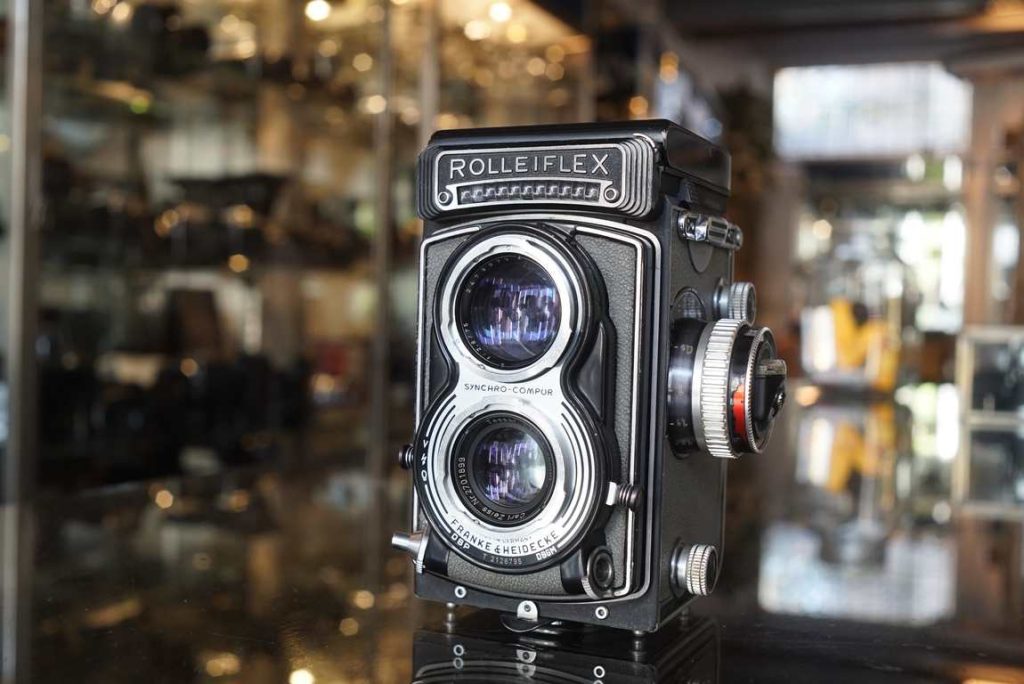 This Rolleiflex T is just back from a CLA over at Amsterdam Camera Repairs. When we bought the camera it was in a not so well shooting condition. The speeds were sluggish and irregular. The winding also was very heavy and not working as it should. The camera's shutter and winding have been disassembled, cleaned and relubricated. The shutter control ring is replaced, cocking gear is replaced, the shutter is calibrated and tested, now perfect. The winding works smooth again. The lenses have been cleaned as best as possible. No haze or fungus inside. Nice clean focusing screen with only some age related scuffs and marks, which don't affect usability. Some scuffs to the meter cover, purely cosmetic. Meter works perfect and accurate on all EV! The meter on the T is uncoupled, so needs some practice but its a beautiful to have addition to your TLR. Nice grey leather T in ready to go condition.this item comes with a 3 month limited warranty